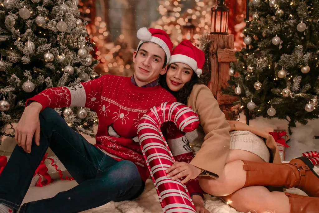 Matching couple costumes - Christmas themed coordinated outfits with Santa hats and festive sweaters