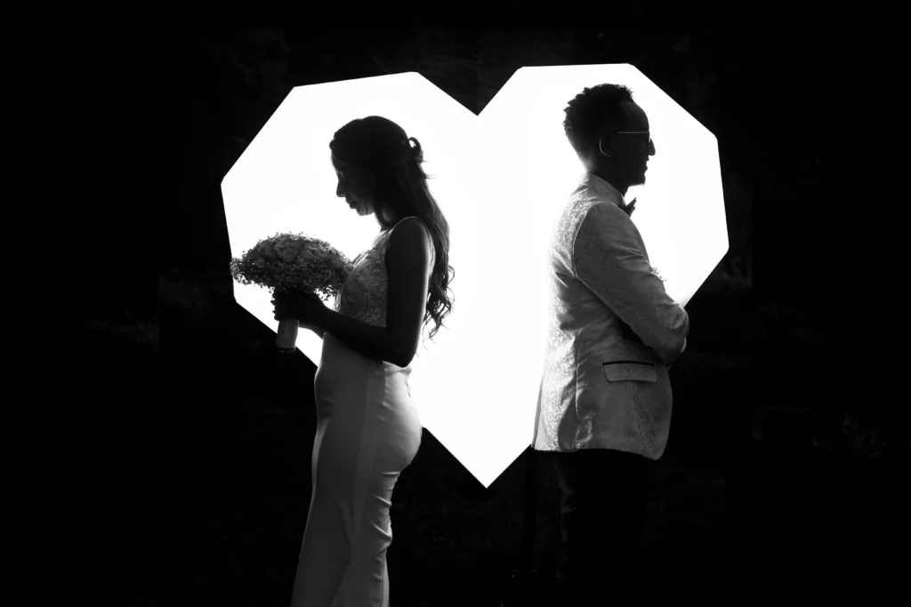 How to tell your husband you want a divorce - bride and groom standing back to back in broken heart frame