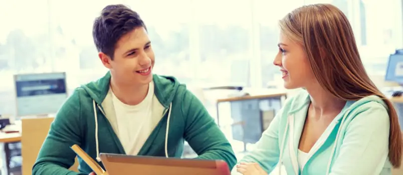 How to approach a girl for the first time - young man having friendly conversation with woman at coffee shop